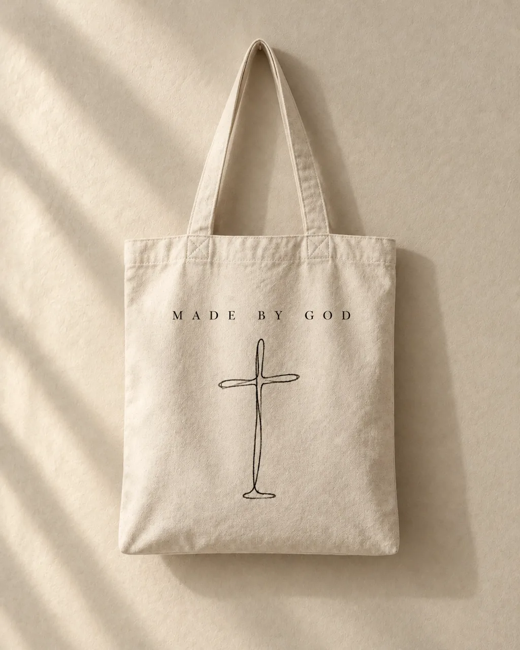 Natural canvas tote printed with Made By God above a line-drawn cross