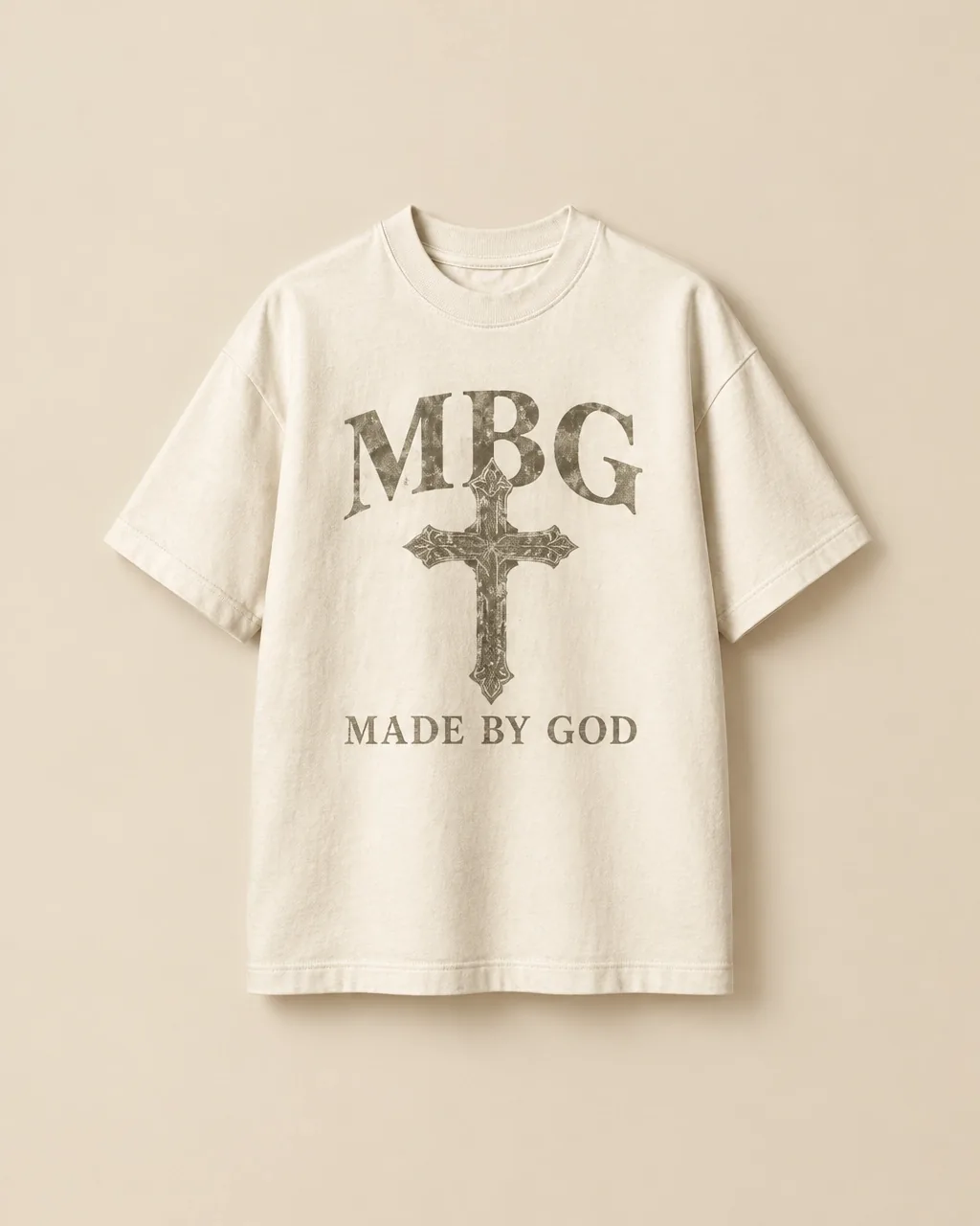 Off-white tee with the MBG cross emblem and Made By God lettering